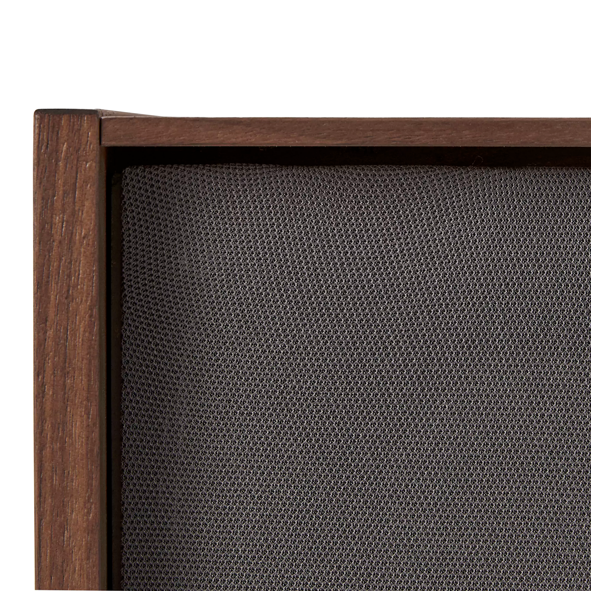 Close-up of fabric speaker grille within the cabinet opening